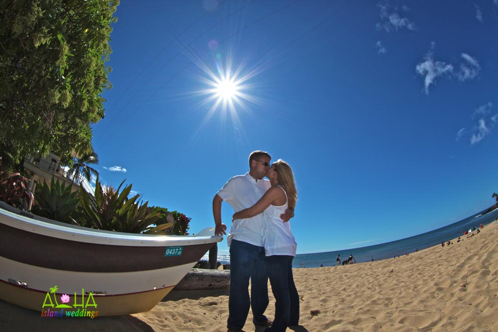 kissing by the boat on the beach